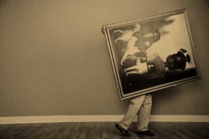 Man Carrying Large Painting --- Image by © Sean Justice/Corbis